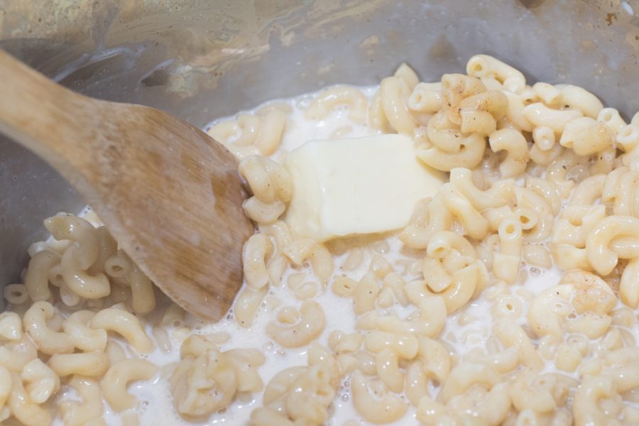 mixing butter with milk and macaroni