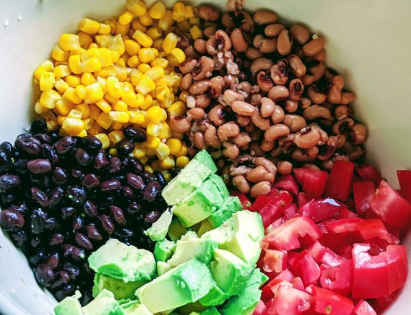 bowl with black beans corn, pinto pbeans, avocado and tomato