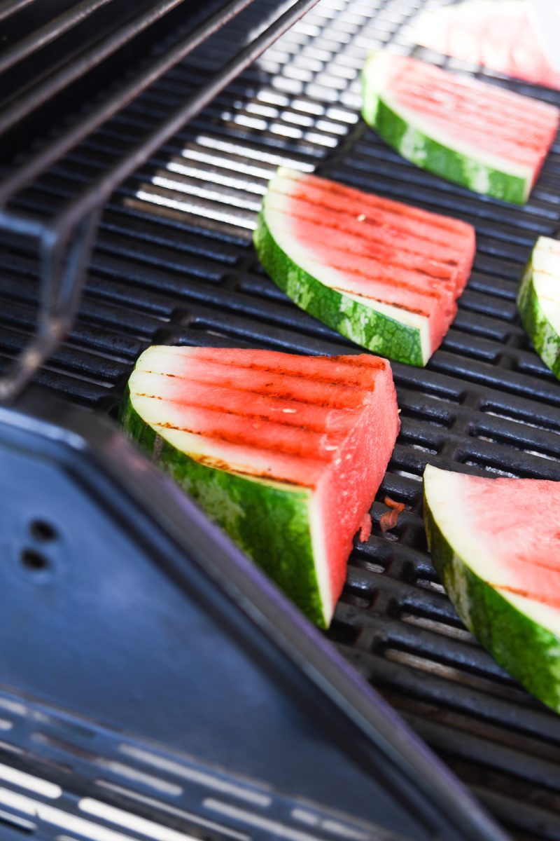 Slices of watermelon on a grill with grill marks