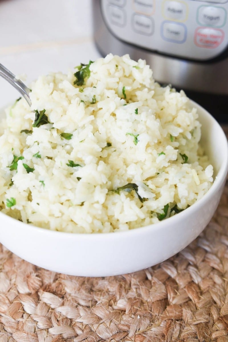 Closeup of cilantro rice with spoon in front of instant pot