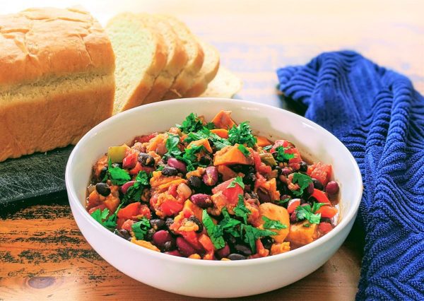 instant pot sweet potato chili in a bowl by bread