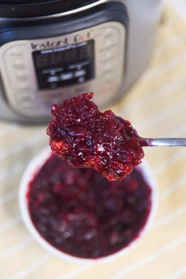 spoonful of cranberry sauce in front of instant pot