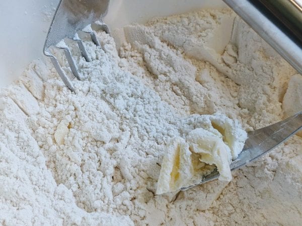 cutting butter into dough 