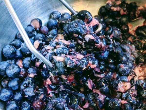 mashing blueberries