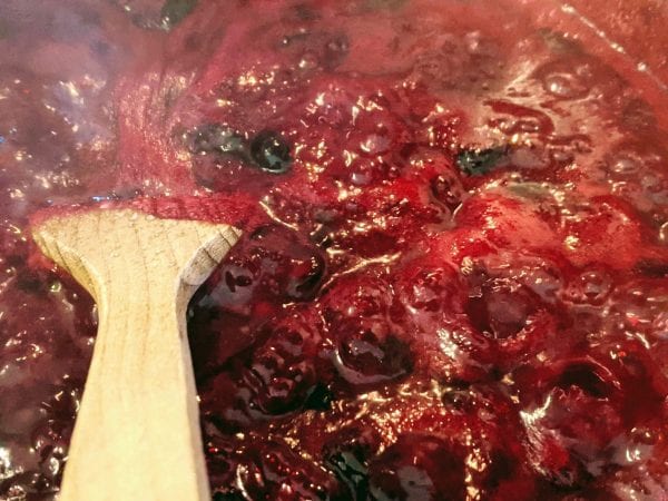 stirring blueberry jam