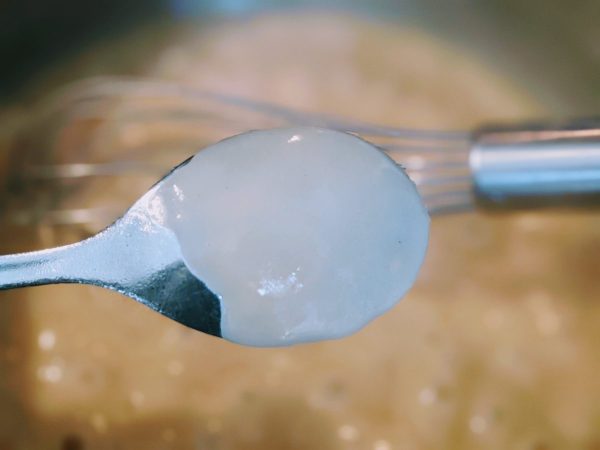 testing gravy thickness with spoon