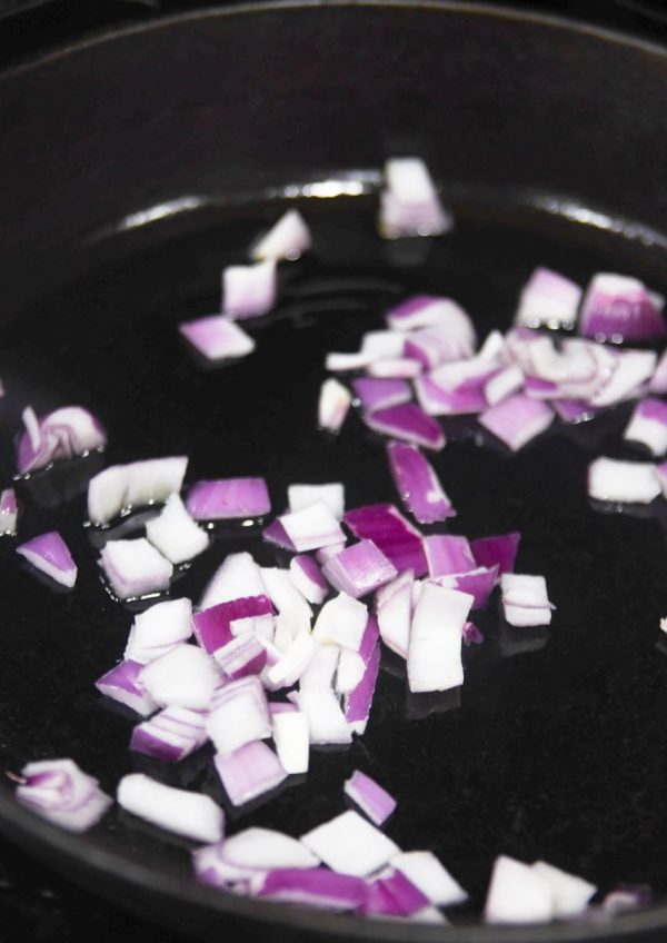 diced red onions in pan