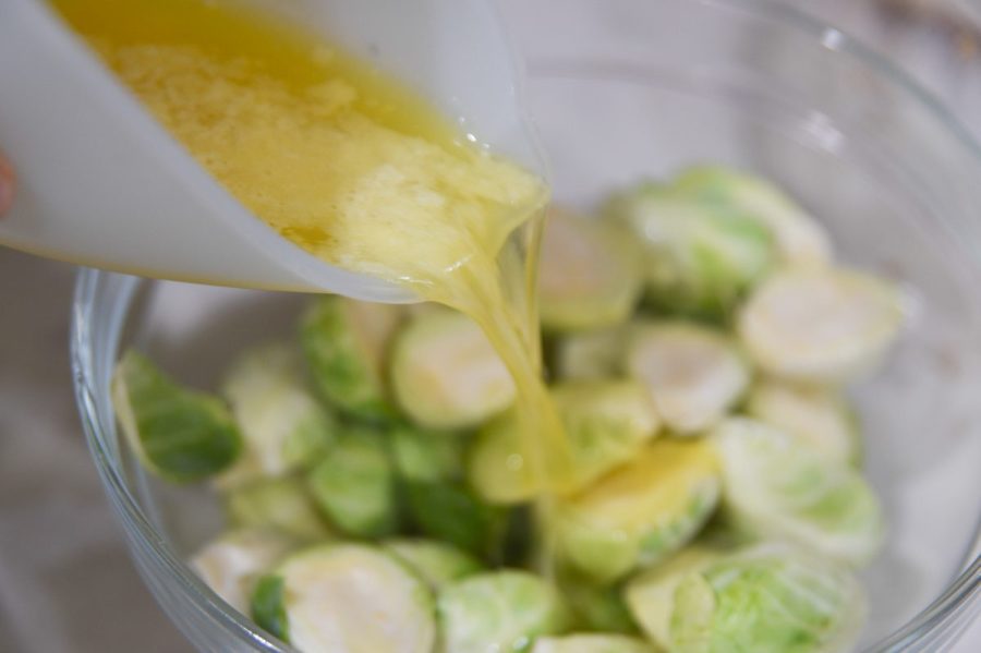 pouring butter on brussel sprouts