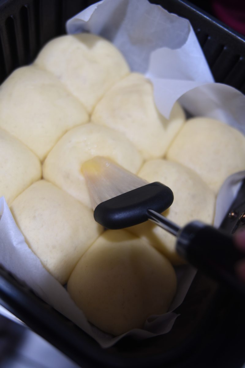 brushing butter on dough