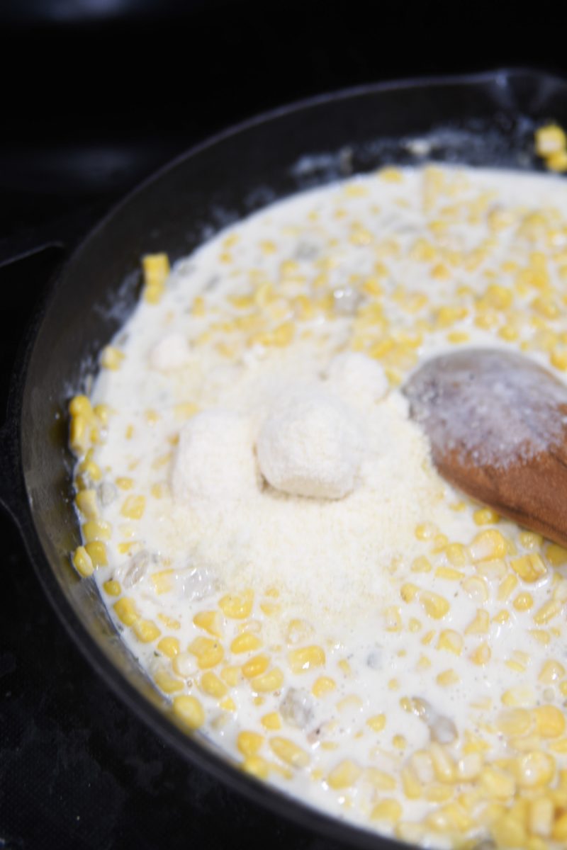 mixing parmesan cheese into creamed corn
