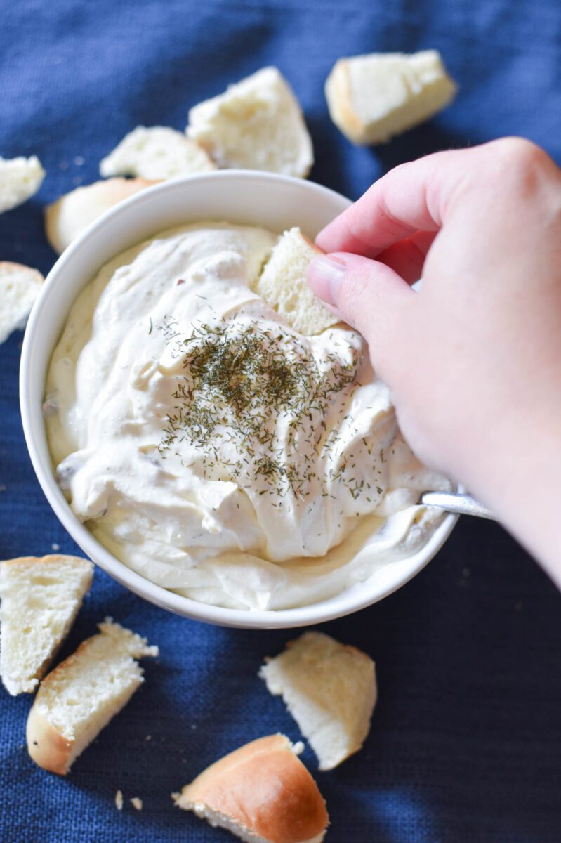 dipping bread in bagel dip