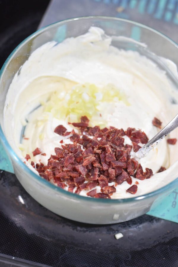 mixing together bagel dip
